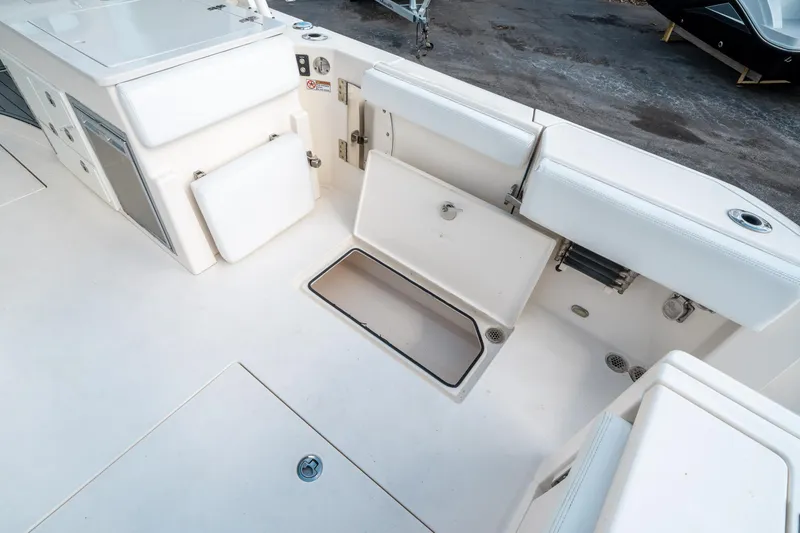 Slide: The Image of 2020 Cobia 330 DC boat interior with open storage compartments. - 14