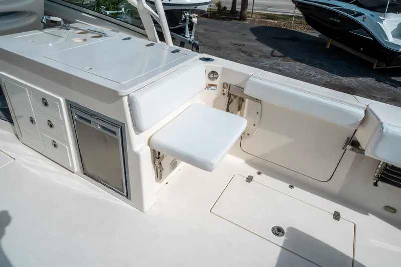 Slide: The Image of 2020 Cobia 330 DC boat interior with seating and storage compartments. - 17