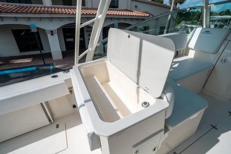 Slide: The Image of 2020 Cobia 330 DC boat interior with open storage compartment. - 21