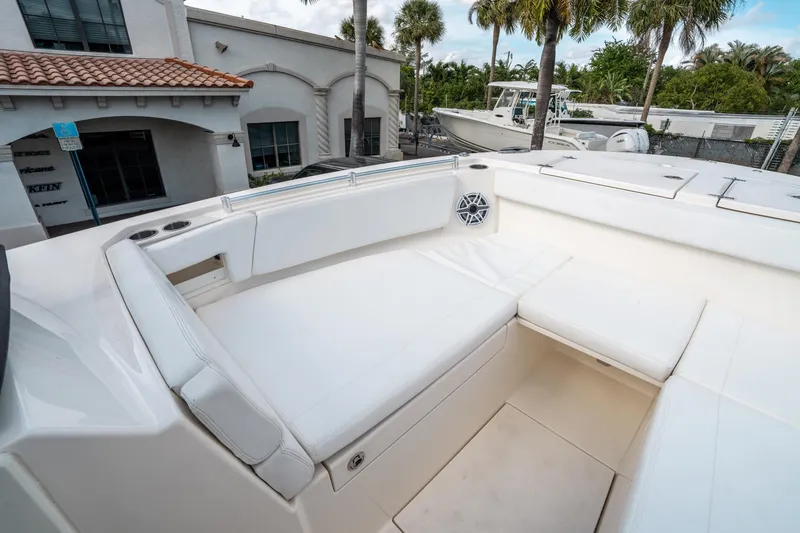 Slide: The Image of 2020 Cobia 330 DC boat interior with white seating and cup holders. - 37