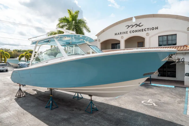 Slide: The Image of 2020 Cobia 330 DC boat displayed at Marine Connection dealership. - 8