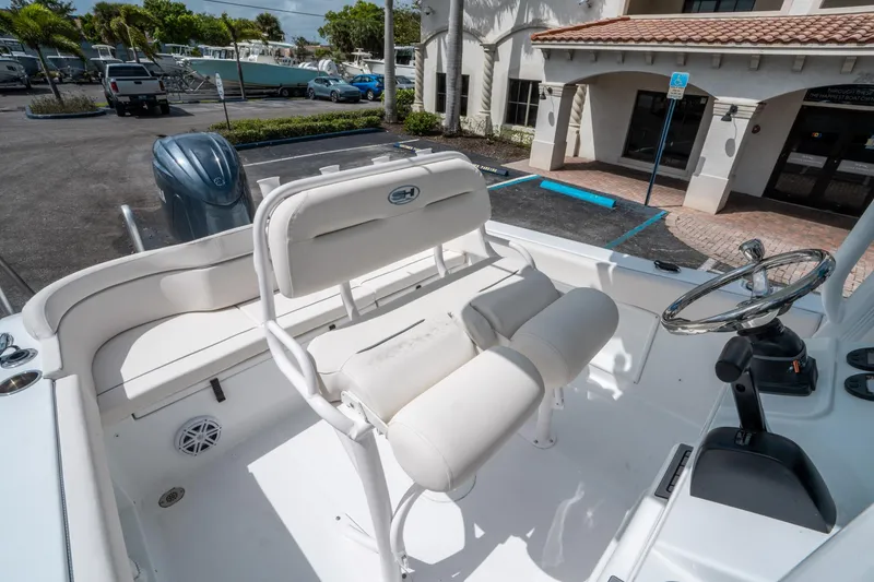 Slide: The Image of 2025 Sea Hunt Ultra 219 boat interior with helm and seating. - 19