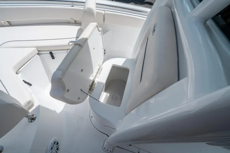 Slide: The Image of 2025 Sea Hunt Ultra 219 boat interior with open storage compartment and seating. - 25
