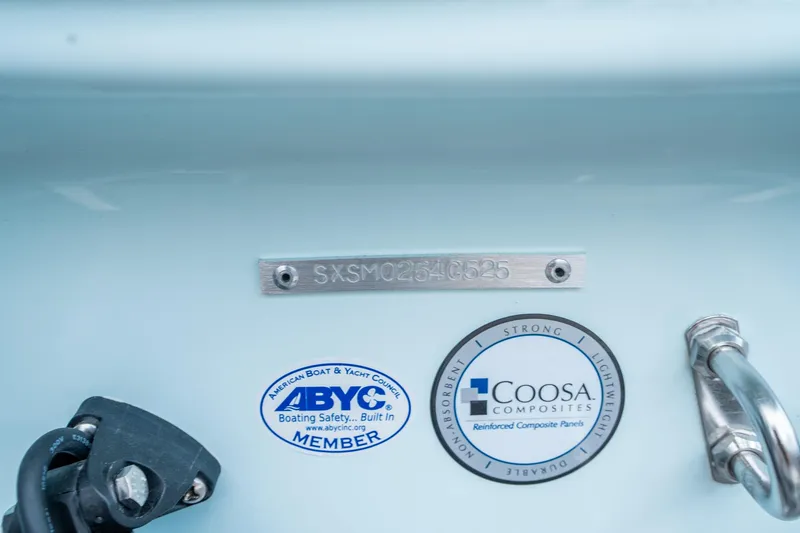 Slide: The Image of 2025 Sea Hunt Ultra 219 boat identification and certification labels, featuring ABYC and Coosa Composites. - 28