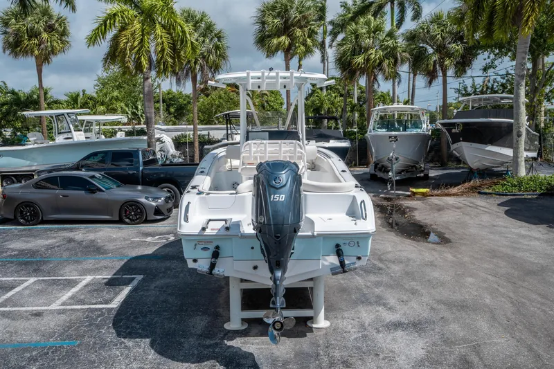 Slide: The Image of 2025 Sea Hunt Ultra 219 boat with Yamaha 150 engine in a marina setting. - 3