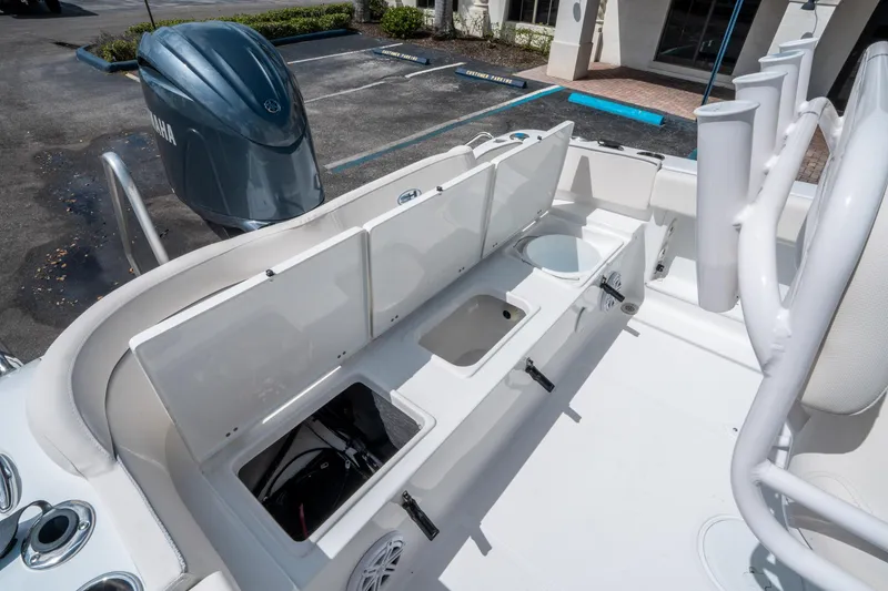 Slide: The Image of 2025 Sea Hunt Ultra 219 boat interior with storage compartments and Yamaha engine. - 13