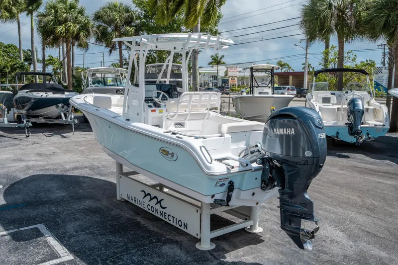 Slide: The Image of 2025 Sea Hunt Ultra 219 boat with Yamaha engine displayed outdoors. - 4