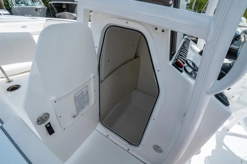 Slide: The Image of 2025 Sea Hunt Ultra 219 boat storage compartment with open door. - 20