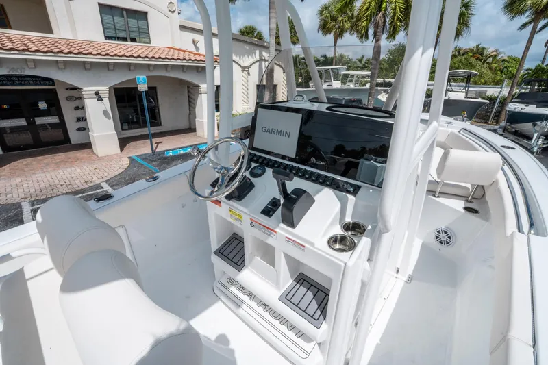 Slide: The Image of 2025 Sea Hunt Ultra 219 boat interior with Garmin navigation system and sleek white design. - 16