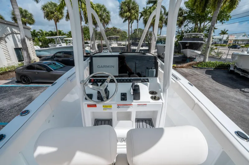 Slide: The Image of 2025 Sea Hunt Ultra 219 boat dashboard with Garmin navigation system, parked outdoors. - 14