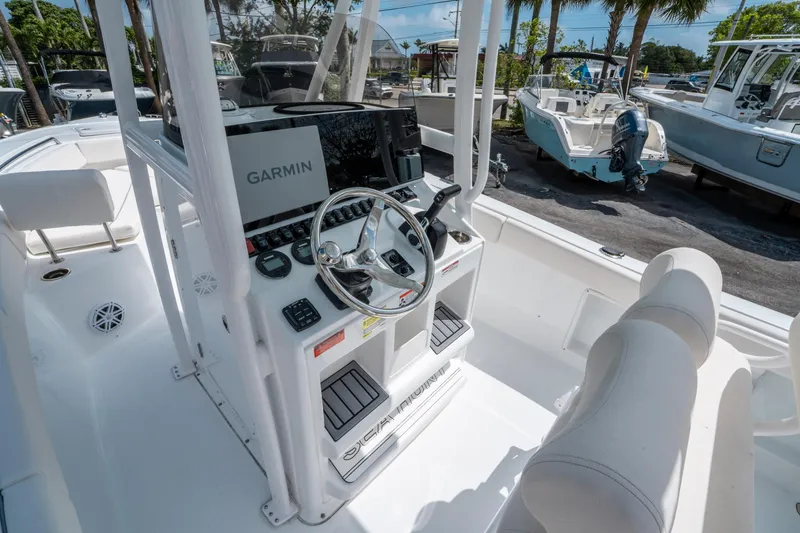 Slide: The Image of 2025 Sea Hunt Ultra 219 boat cockpit with Garmin navigation system and steering wheel. - 15