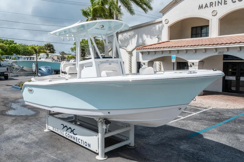 Slide: The Image of 2025 Sea Hunt Ultra 219 boat displayed at Marine Connection dealership. - 8