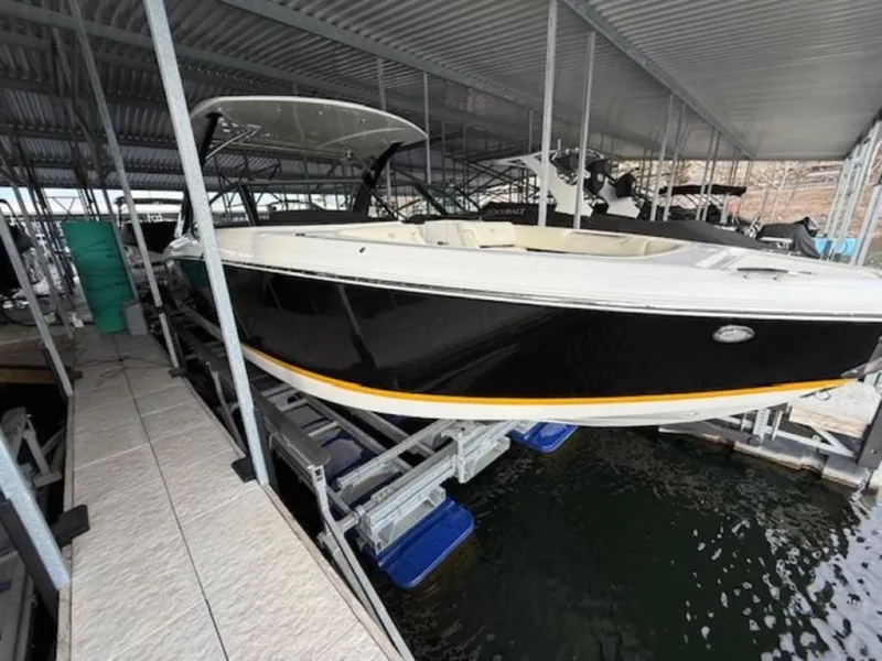 Slide: The Image of 2020 Cobalt R30 boat docked in a covered marina. - 0