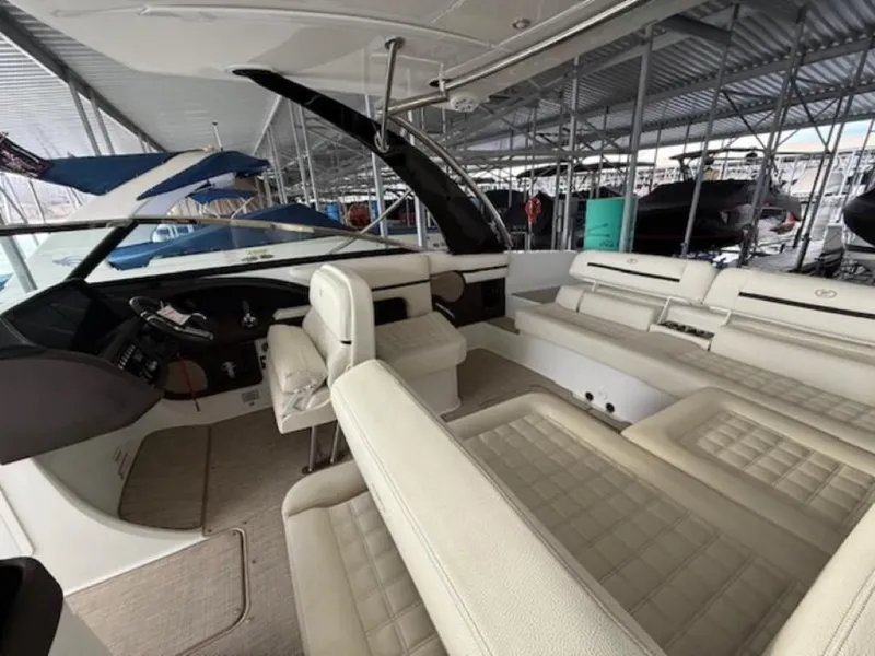 Slide: The Image of 2020 Cobalt R30 boat interior with white seating in a marina. - 12