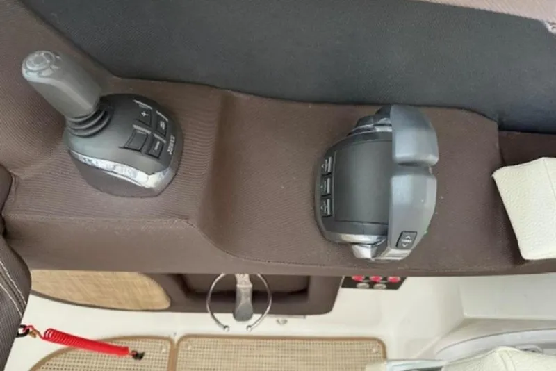 Slide: The Image of 2020 Cobalt R30 boat controls, featuring joystick and throttle on brown panel. - 15