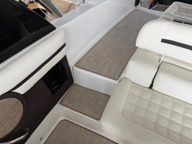 Slide: The Image of 2020 Cobalt R30 boat interior with white cushioned seating and beige flooring. - 8