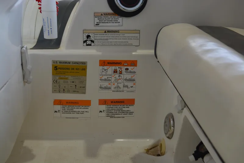 Slide: The Image of 2016 Walker Bay Generation 340 DLX boat interior with safety warning labels. - 11