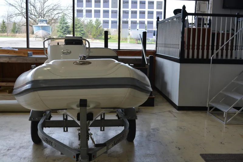Slide: The Image of 2016 Walker Bay Generation 340 DLX boat displayed indoors on a trailer. - 3