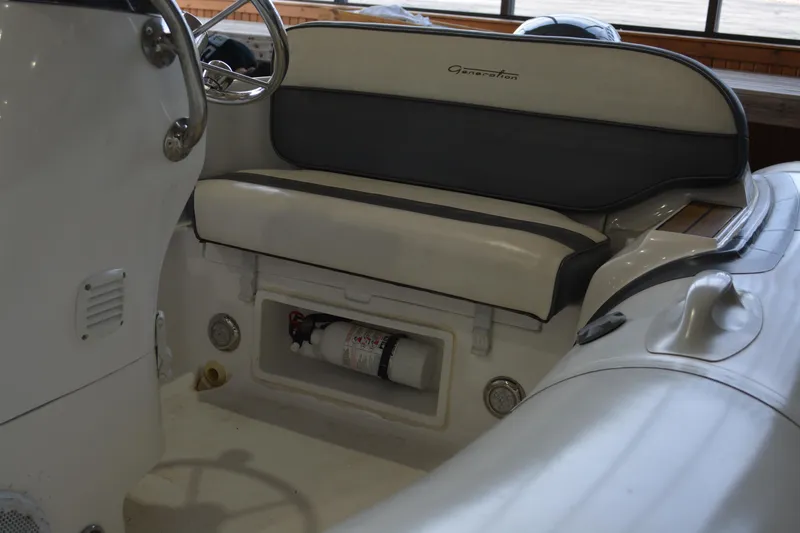 Slide: The Image of 2016 Walker Bay Generation 340 DLX boat interior with seating and fire extinguisher. - 8