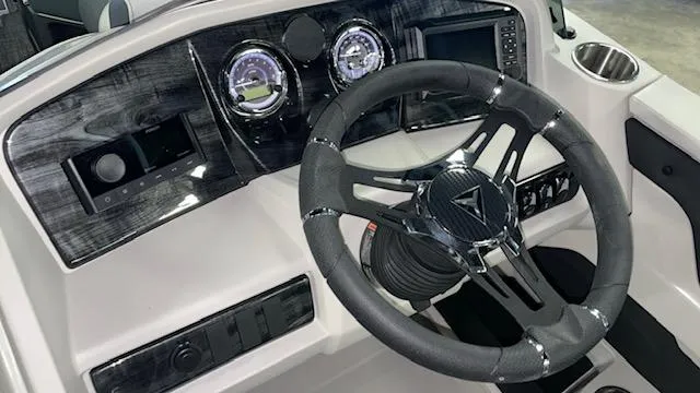 Slide: The Image of 2025 Tahoe LTZ 2385 RL boat dashboard with modern steering wheel and gauges. - 7