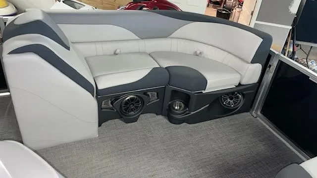 Slide: The Image of 2025 Tahoe LTZ 2385 RL boat interior with gray seating and built-in speakers. - 9