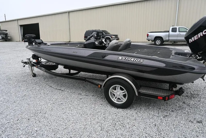 Slide: The Image of 2012 Stratos 189VLO boat on trailer in gravel lot, side view. - 4