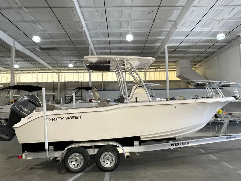Slide: The Image of 2023 Key West 239 FS boat on trailer in indoor storage facility. - 0