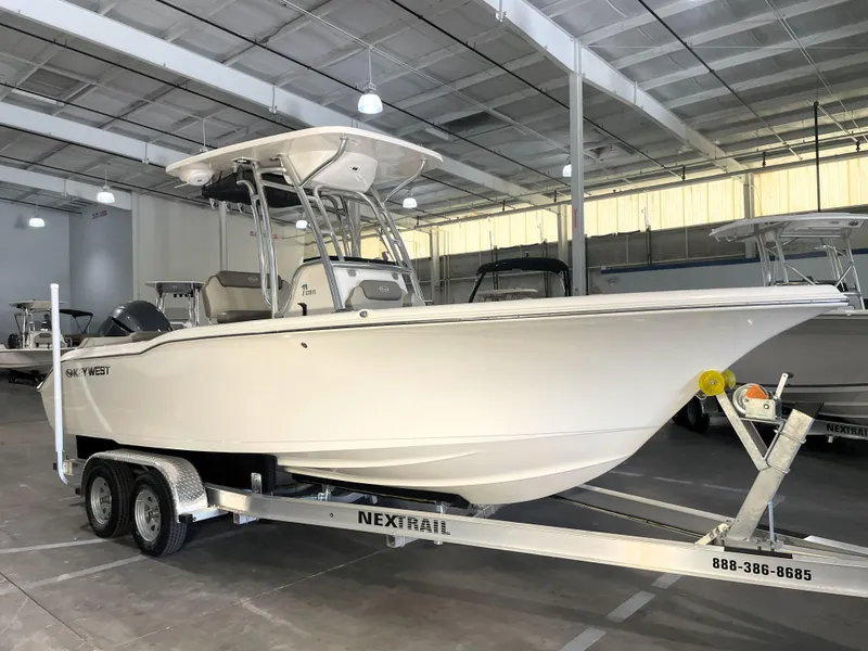 Slide: The Image of 2023 Key West 239 FS boat on trailer in indoor showroom. - 1
