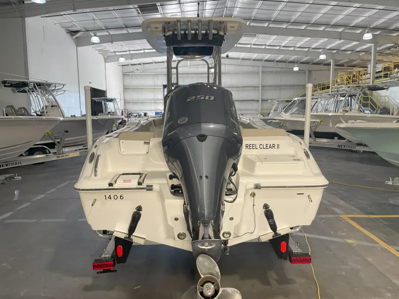 Slide: The Image of 2023 Key West 239 FS boat in a warehouse, rear view with outboard motor. - 10