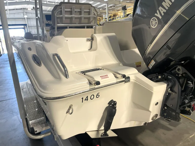 Slide: The Image of 2023 Key West 239 FS boat with Yamaha engine in a storage facility. - 11