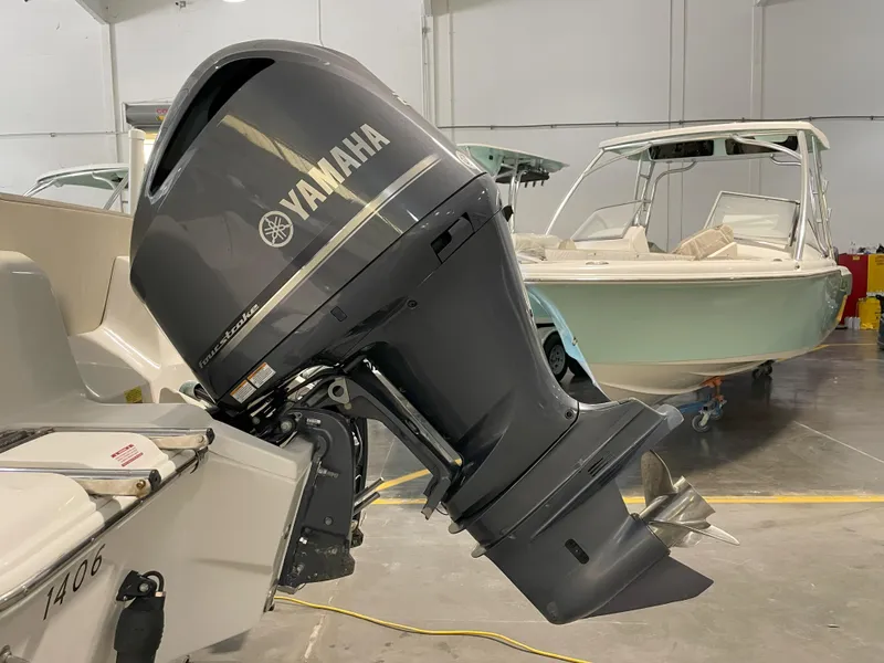 Slide: The Image of 2023 Key West 239 FS boat with Yamaha outboard motor in a showroom. - 14