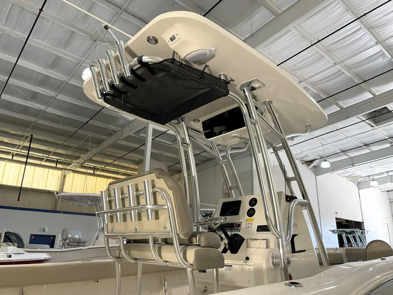 Slide: The Image of 2023 Key West 239 FS boat interior with T-top and rod holders in a showroom. - 16
