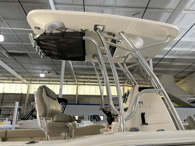 Slide: The Image of 2023 Key West 239 FS boat with T-top and seating in a showroom. - 17