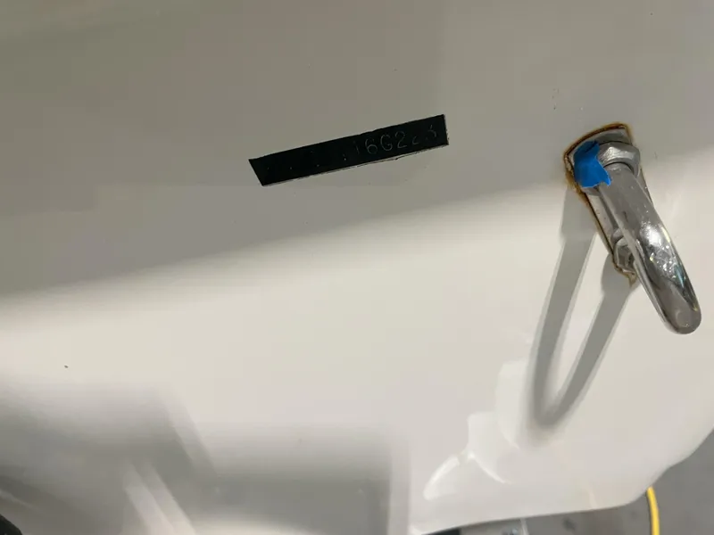 Slide: The Image of 2023 Key West 239 FS boat detail with metal handle and black label. - 18