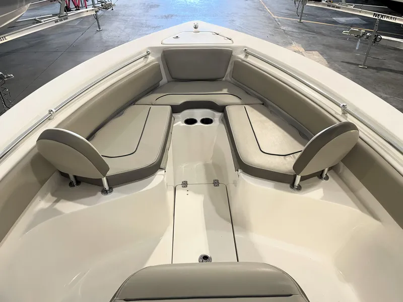 Slide: The Image of 2023 Key West 239 FS boat interior with cushioned seating and cup holders. - 19