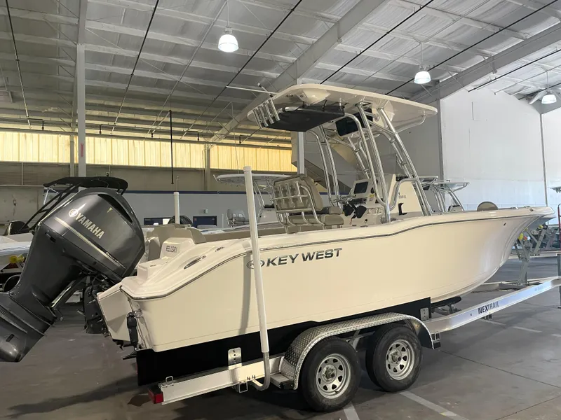 Slide: The Image of 2023 Key West 239 FS boat on trailer in indoor storage facility. - 2