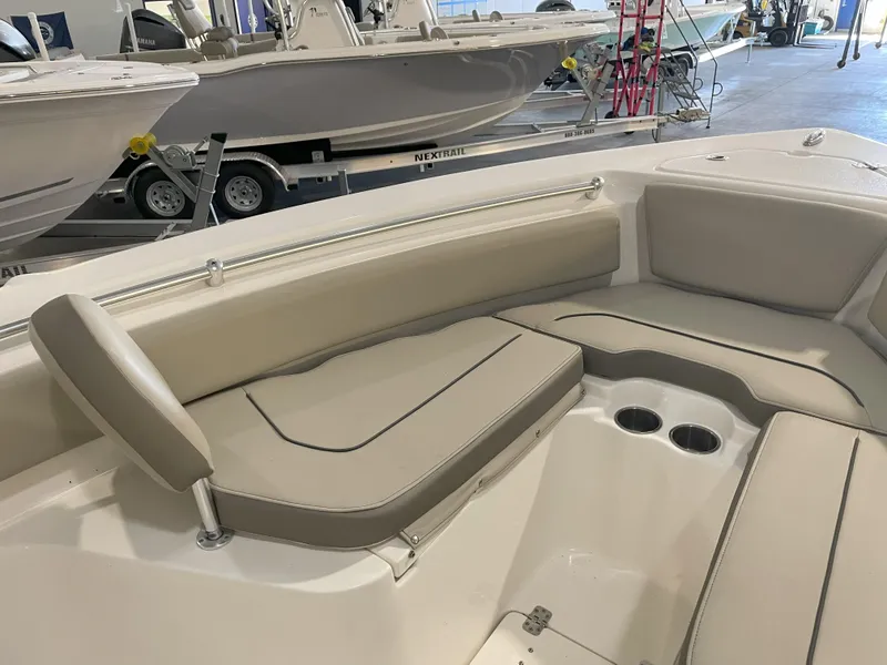 Slide: The Image of 2023 Key West 239 FS boat interior with beige seating and cup holders. - 20