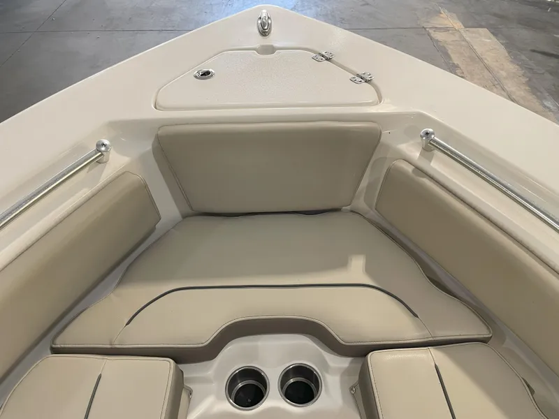 Slide: The Image of 2023 Key West 239 FS boat interior with cushioned seating and cup holders. - 22