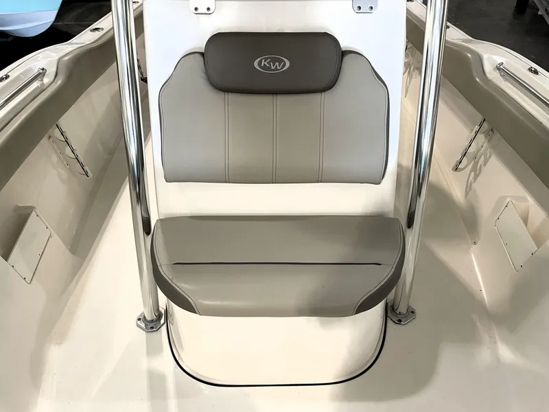 Slide: The Image of 2023 Key West 239 FS boat interior with cushioned seating and stainless steel rails. - 24