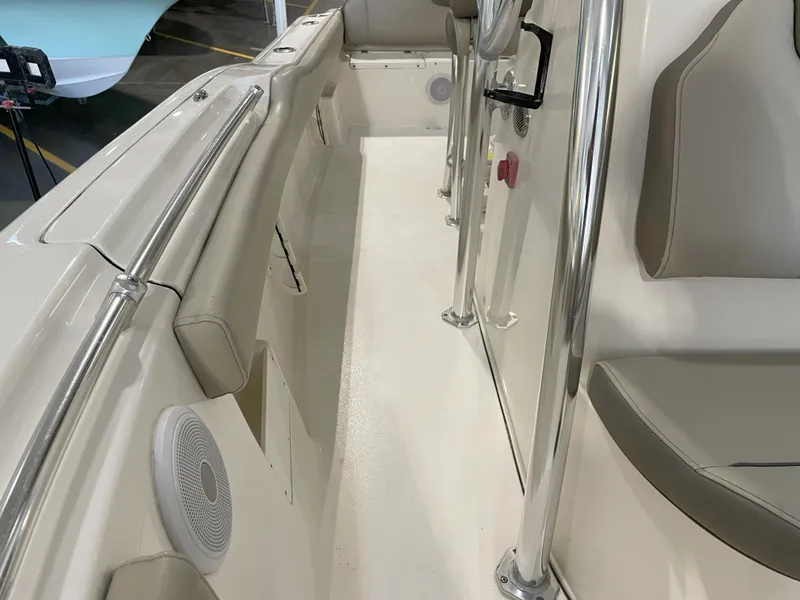 Slide: The Image of 2023 Key West 239 FS boat interior with beige seating and stainless steel railings. - 27