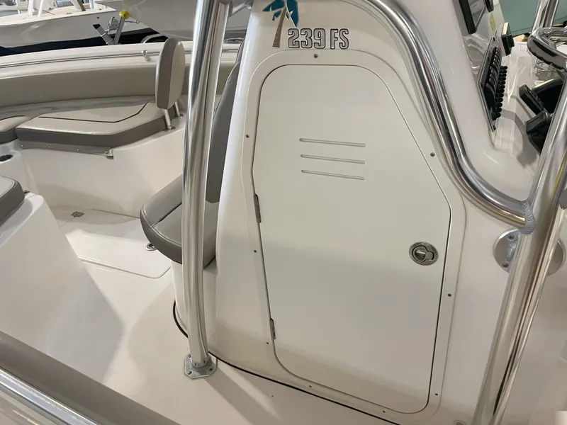 Slide: The Image of 2023 Key West 239 FS boat interior with seating and console details. - 29