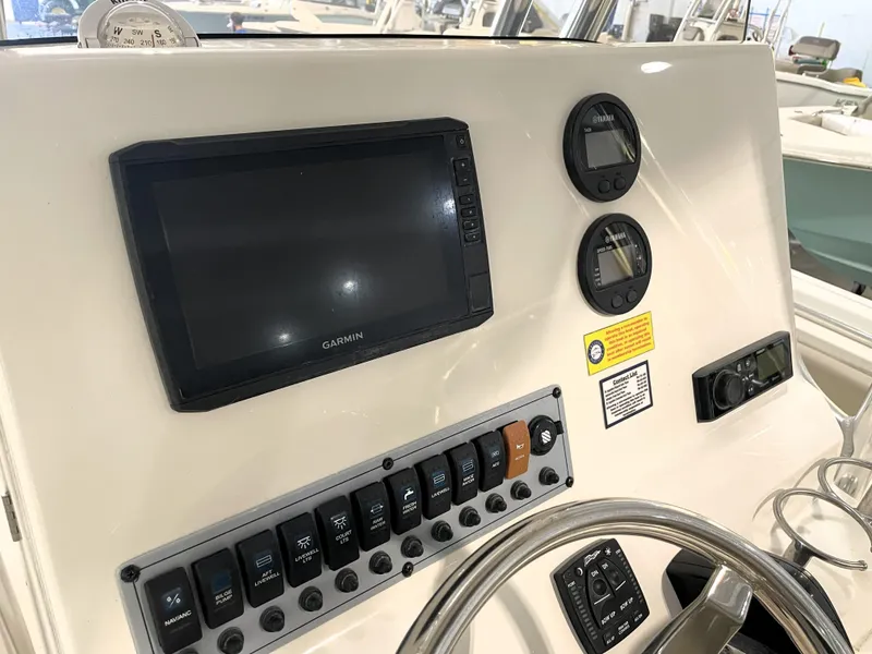 Slide: The Image of 2023 Key West 239 FS boat dashboard with Garmin display and control panel. - 34