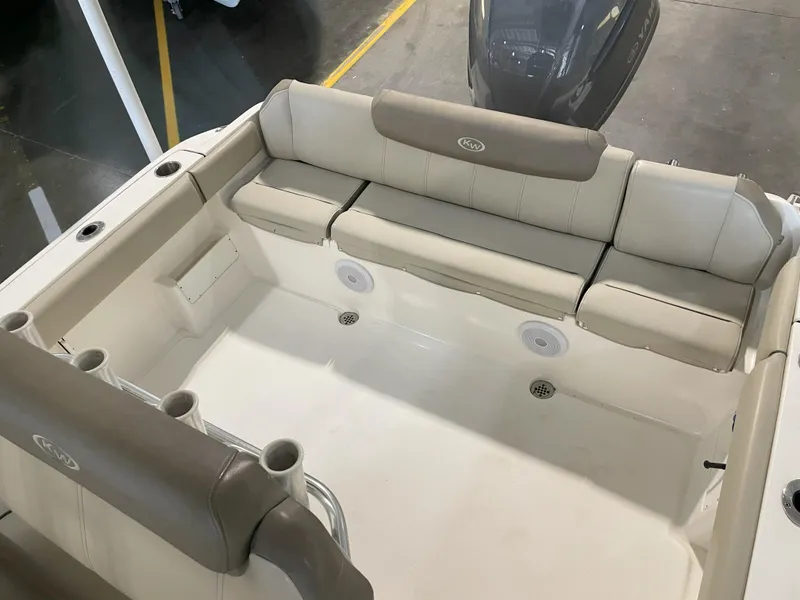 Slide: The Image of 2023 Key West 239 FS boat interior with cushioned seating and cup holders. - 37