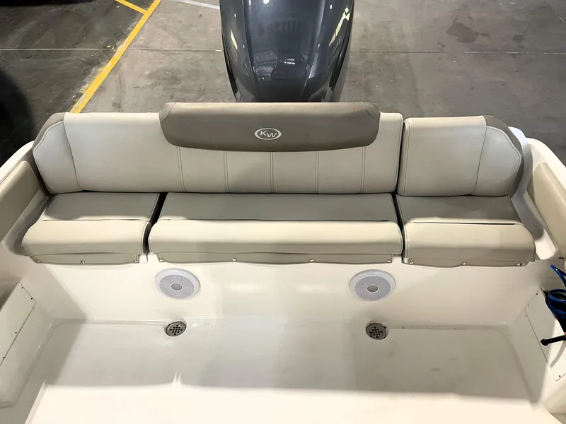 Slide: The Image of 2023 Key West 239 FS boat with cushioned seating and built-in speakers. - 38
