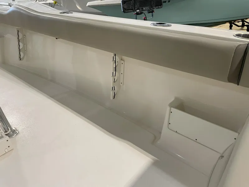 Slide: The Image of 2023 Key West 239 FS boat interior with cushioned seating and storage compartments. - 41