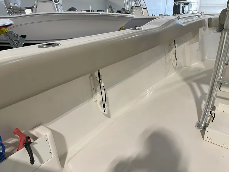 Slide: The Image of 2023 Key West 239 FS boat interior with clean, white deck and railing. - 42