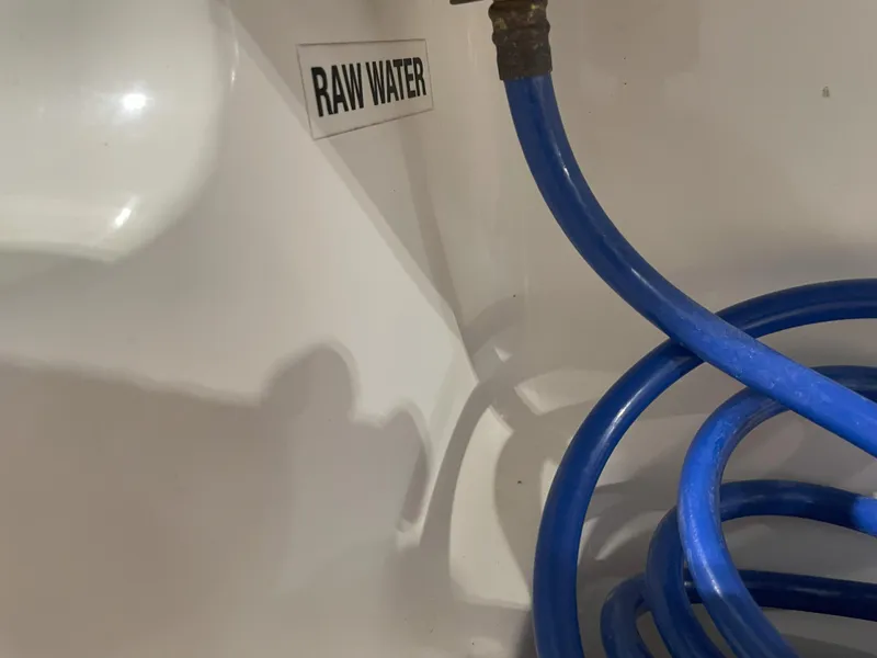 Slide: The Image of Blue hose labeled "Raw Water" in 2023 Key West 239 FS boat. - 43