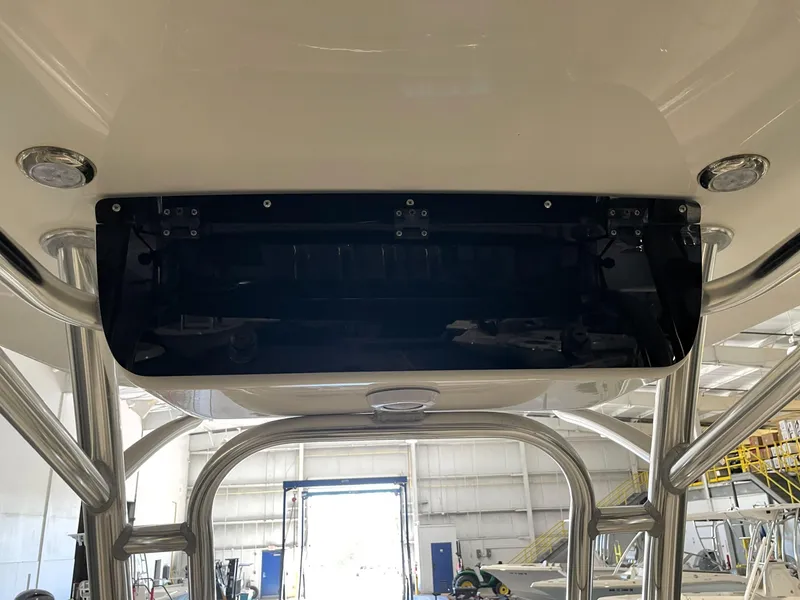 Slide: The Image of 2023 Key West 239 FS boat interior, featuring a sleek overhead compartment in a well-lit garage. - 44