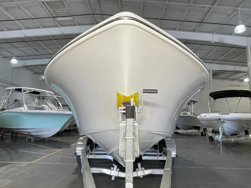 Slide: The Image of 2023 Key West 239 FS boat in showroom, front view on trailer. - 7