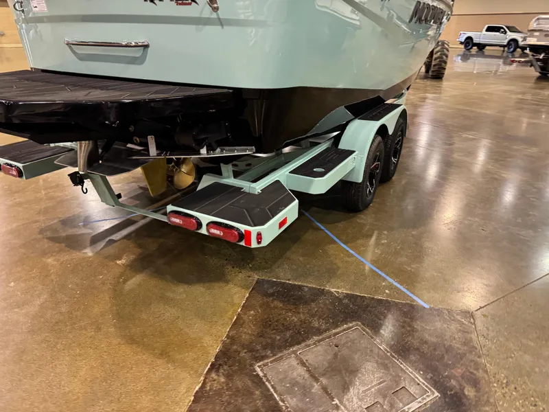 Slide: The Image of 2025 Moomba Max boat on trailer, displayed indoors on polished concrete floor. - 10
